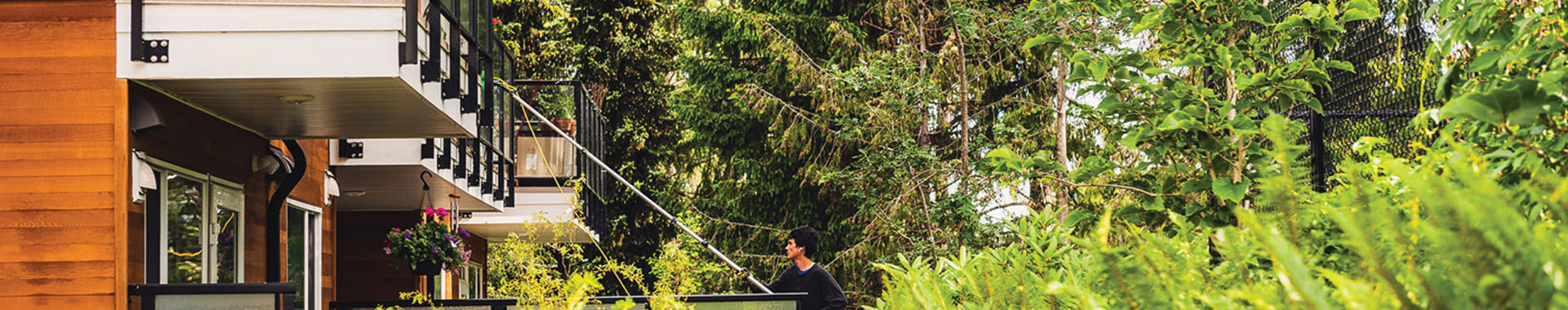man cleaning windows from the ground